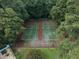 Aerial view of community tennis courts surrounded by trees, providing privacy for residents at 3091 Colonial Way # E4, Chamblee, GA 30341