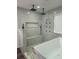 Modern bathroom featuring double shower heads, tiled walls, and a luxurious soaking tub at 95 Jenna Ln, Covington, GA 30016