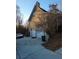 Side view of a house with a two-car garage and a driveway, plus basketball hoop at 95 Jenna Ln, Covington, GA 30016