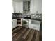 An updated kitchen with stainless steel appliances, granite countertops, and white cabinetry at 95 Jenna Ln, Covington, GA 30016