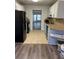 A kitchen featuring tile and wood flooring with white cabinetry at 95 Jenna Ln, Covington, GA 30016