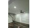 Modern living room with hardwood floors, paneling, front door and staircase at 95 Jenna Ln, Covington, GA 30016
