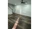 Modern living room with hardwood floors, paneling, front door and staircase at 95 Jenna Ln, Covington, GA 30016