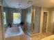 Bathroom with garden tub, shower, and large window at 1417 Doe Valley Dr, Lithonia, GA 30058