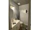 Small bathroom with white vanity, toilet, and zebra rug at 1417 Doe Valley Dr, Lithonia, GA 30058