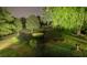 Expansive front yard with mature trees and landscaping at night at 1417 Doe Valley Dr, Lithonia, GA 30058