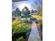 Landscaped front yard with a paved walkway leading to the house at 1417 Doe Valley Dr, Lithonia, GA 30058