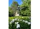 Beautiful garden with blooming white flowers and a classic lamp post at 1417 Doe Valley Dr, Lithonia, GA 30058