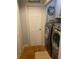 Laundry room with washer, dryer, and wood flooring at 1417 Doe Valley Dr, Lithonia, GA 30058