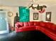 Living room with red sectional sofa and eclectic decor at 1417 Doe Valley Dr, Lithonia, GA 30058