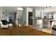 Open living and kitchen area with hardwood floors, white cabinets and a breakfast bar at 1417 Doe Valley Dr, Lithonia, GA 30058
