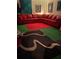 Living room with red sectional and patterned rugs at 1417 Doe Valley Dr, Lithonia, GA 30058