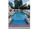 Inviting in-ground pool with brick coping, surrounded by lush landscaping at 1417 Doe Valley Dr, Lithonia, GA 30058