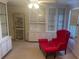Sitting room with built-in white cabinets, display cases, and a red armchair at 1417 Doe Valley Dr, Lithonia, GA 30058