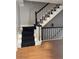 Classic staircase with black carpeting and hardwood floors at 1417 Doe Valley Dr, Lithonia, GA 30058