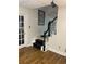Stairs with black railing and wood flooring at 1417 Doe Valley Dr, Lithonia, GA 30058