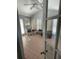 Sunroom with pink tile floor, white wicker chair, and shutters at 1417 Doe Valley Dr, Lithonia, GA 30058