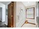 Small bathroom with window, wood flooring, and white towels at 3133 Callie Still Rd, Lawrenceville, GA 30045