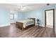 Light blue bedroom with wood flooring and a ceiling fan at 3133 Callie Still Rd, Lawrenceville, GA 30045