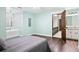 Light green bedroom with wood floors and a built-in bathtub at 3133 Callie Still Rd, Lawrenceville, GA 30045