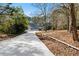 Long driveway leading to a spacious house on a wooded lot at 3133 Callie Still Rd, Lawrenceville, GA 30045