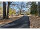 Curving driveway to charming house nestled among mature trees at 3133 Callie Still Rd, Lawrenceville, GA 30045