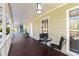 Relaxing front porch with wooden floor and seating area at 3133 Callie Still Rd, Lawrenceville, GA 30045