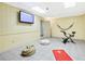 Basement gym with stationary bike, yoga mat and beanbag chair at 3133 Callie Still Rd, Lawrenceville, GA 30045