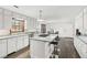 Modern kitchen with white cabinets, granite countertops, and an island at 3133 Callie Still Rd, Lawrenceville, GA 30045