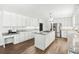 Spacious kitchen with white cabinets, granite countertops, and an island at 3133 Callie Still Rd, Lawrenceville, GA 30045