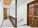 Upstairs hallway with carpet, wooden railing, and doors to bedrooms at 3133 Callie Still Rd, Lawrenceville, GA 30045