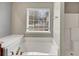 Bathroom featuring a large soaking tub and a window offering natural light at 141 Whimsical Ct, Locust Grove, GA 30248
