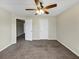 Neutral-toned bedroom with a ceiling fan, plush carpet, and bright white trim at 141 Whimsical Ct, Locust Grove, GA 30248