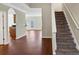 Inviting entryway with view of the living area and a staircase with carpeted steps at 141 Whimsical Ct, Locust Grove, GA 30248