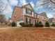 Two-story home featuring brick and siding, with an attached garage and manicured shrubs at 141 Whimsical Ct, Locust Grove, GA 30248