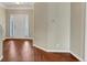 Bright foyer featuring hardwood floors, a white front door with sidelights, and neutral wall paint at 141 Whimsical Ct, Locust Grove, GA 30248