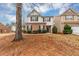 Charming two-story home with a brick facade, black shutters, and well-maintained landscaping at 141 Whimsical Ct, Locust Grove, GA 30248