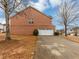 Brick home with an attached garage and a well-manicured lawn, nestled among mature trees at 141 Whimsical Ct, Locust Grove, GA 30248
