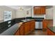 Kitchen counter featuring sleek dark granite countertops and stainless steel appliances at 141 Whimsical Ct, Locust Grove, GA 30248