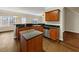 Open kitchen with stainless steel appliances, a granite island, and an adjoining breakfast bar at 141 Whimsical Ct, Locust Grove, GA 30248