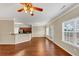 Bright open-concept living area featuring hardwood floors and a view of the kitchen at 141 Whimsical Ct, Locust Grove, GA 30248