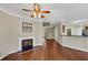 Open living space featuring hardwood floors, a fireplace, and a view into the kitchen at 141 Whimsical Ct, Locust Grove, GA 30248