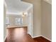 Open living room with hardwood floors, a ceiling fan, and a view of the backyard at 141 Whimsical Ct, Locust Grove, GA 30248