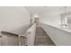 Bright upstairs hallway with wood-look flooring and safety gate at 213 Expedition Dr, Ellenwood, GA 30294