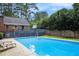 Inviting in-ground pool with spacious deck, lush landscaping, and a relaxing atmosphere at 5513 N Peachtree Rd, Dunwoody, GA 30338