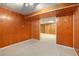 Unfinished basement area with wood paneled walls at 5513 N Peachtree Rd, Dunwoody, GA 30338