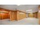 Spacious finished basement with wood paneling and neutral carpeting at 5513 N Peachtree Rd, Dunwoody, GA 30338