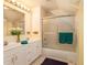 Bright bathroom with double vanity, shower/tub combo, and updated fixtures at 5513 N Peachtree Rd, Dunwoody, GA 30338