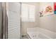 Bathroom with a shower/tub combo and window at 5513 N Peachtree Rd, Dunwoody, GA 30338