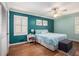 Main bedroom with hardwood floors and teal and mint colored walls at 5513 N Peachtree Rd, Dunwoody, GA 30338